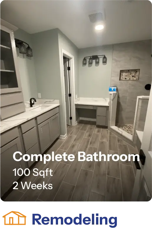 Modern complete bathroom remodel featuring stylish gray cabinetry, double sinks, and a spacious walk-in shower. The design emphasizes functionality in a 100 square foot area, completed in two weeks. Ideal for homeowners seeking contemporary bathroom upgrades.