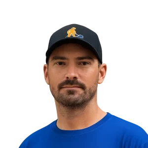 Josh O’Connell in a blue shirt and cap with "Bluecollar Scholars Landscapes" logo.