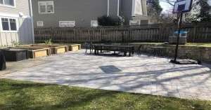 Backyard paver patio with a raised garden