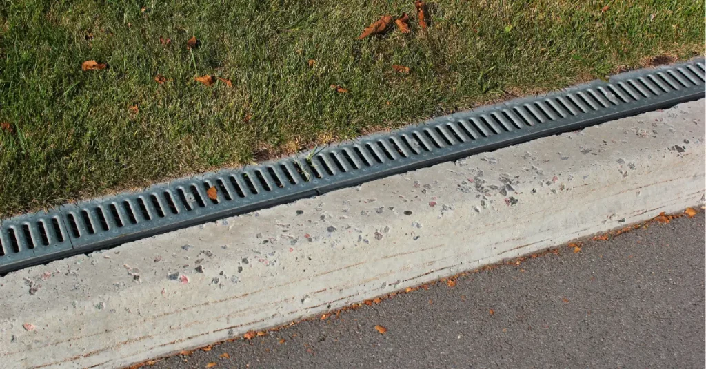 Residential drainage system channel installed along driveway for effective surface water management and home protection