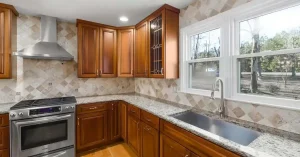 Kitchen Remodeling: modern wooden cabinets with a marbled countertop