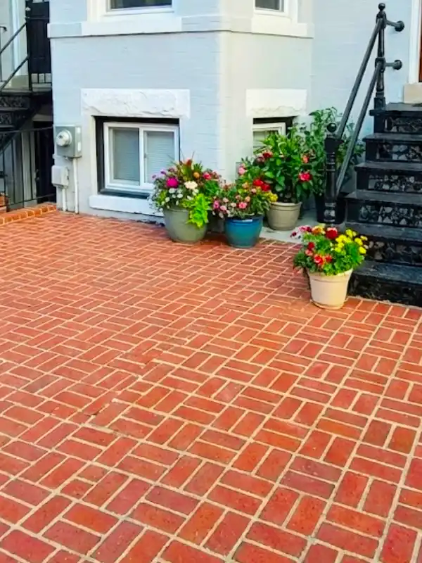 Custom brick patio by hardscape contractors in Capitol Hill, DC, with matched historic bricks and concrete foundation