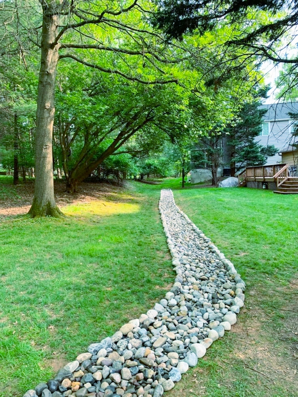Hardscape Services in Silver Spring, MD. The Blue Collar Scholars team previously installed the river gravel swale.