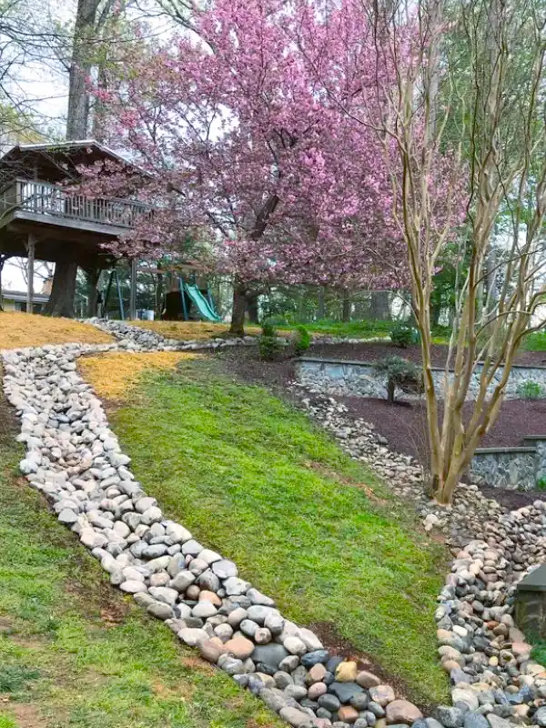Hardscape services in Columbia, MD featuring a professionally engineered gravel swale installed by Blue Collar Scholars.