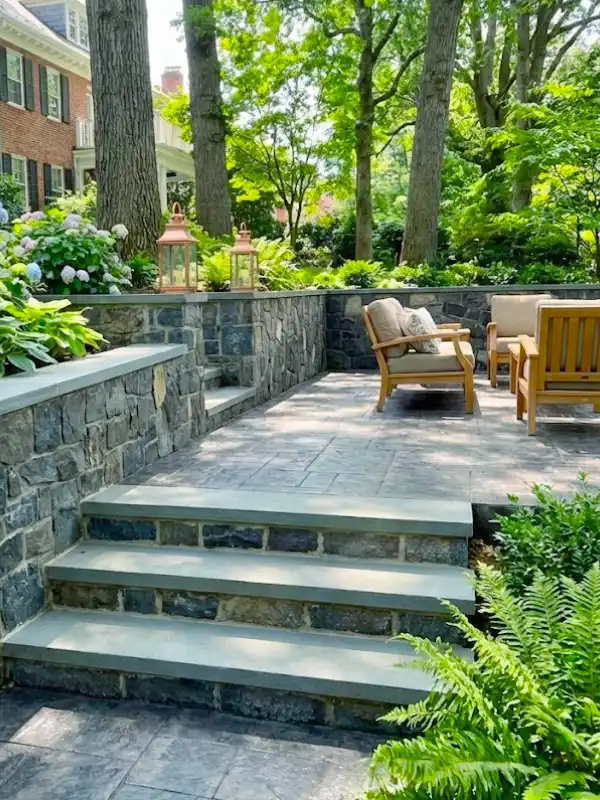 Stacked stone retaining walls and stamped concrete patio installed by hardscape contractors in Cathedral Heights, DC