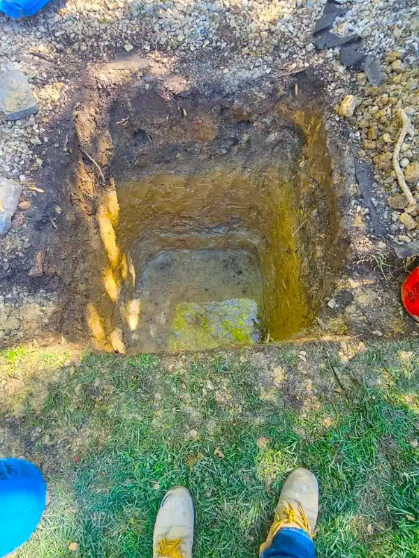 A deep square hole excavated for a dry well installation in the DMV area.