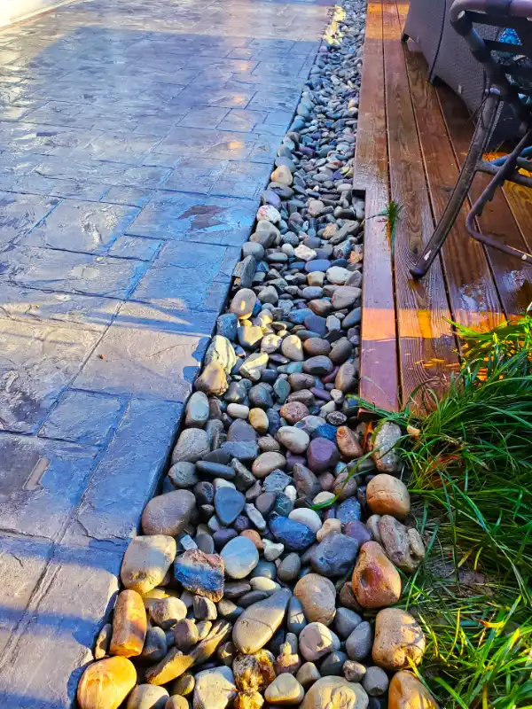 Yard drainage contractors custom solution next to a thermal bluestone walkway to prevent flooding in Washington, DC.