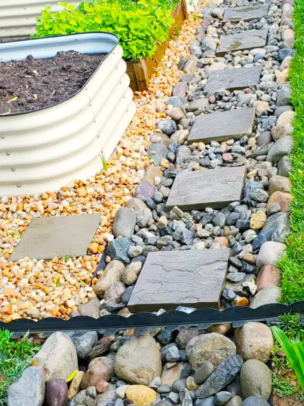 Yard drainage solution with a rock channel and stepping stones to prevent water buildup in Maryland.