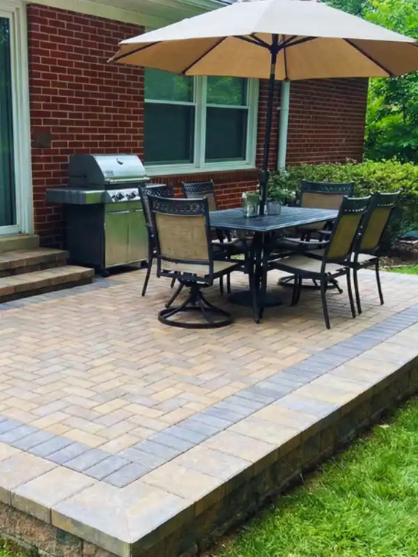 Custom outdoor living project showcasing a brick patio with an outdoor kitchen