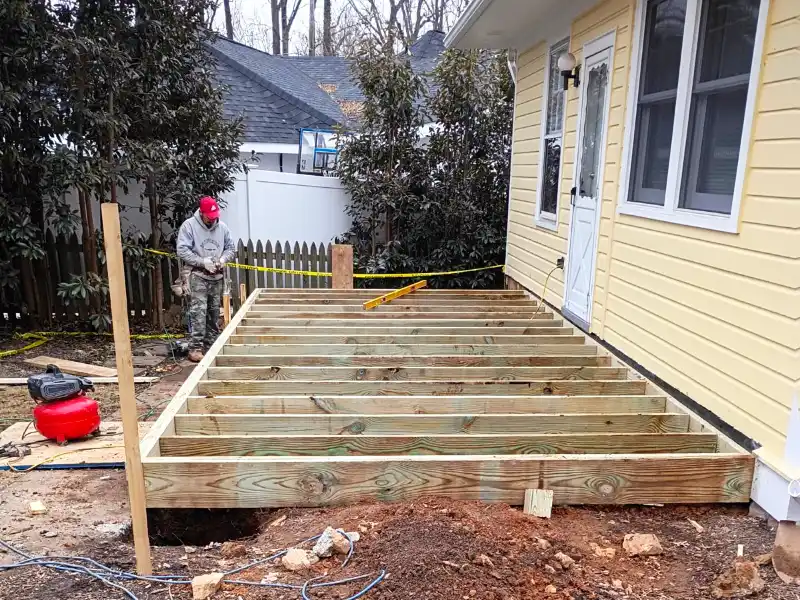 The 20-by-10 structural floor frame is established using new joists tied directly to the house's foundation level.
