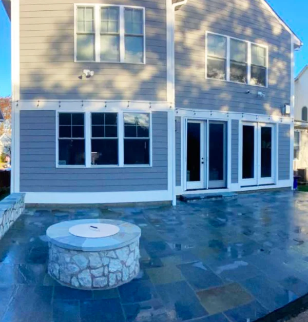 Completed Pennsylvania Bluestone patio with sitting wall and fire pit in Kensington MD