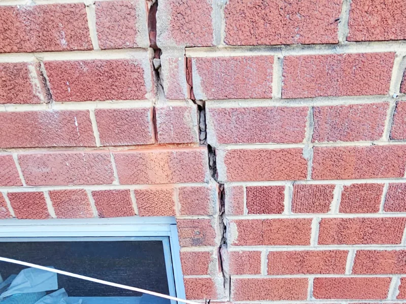 Close view mortar joint cracking on exterior brick wall before repair in Temple Hills, MD