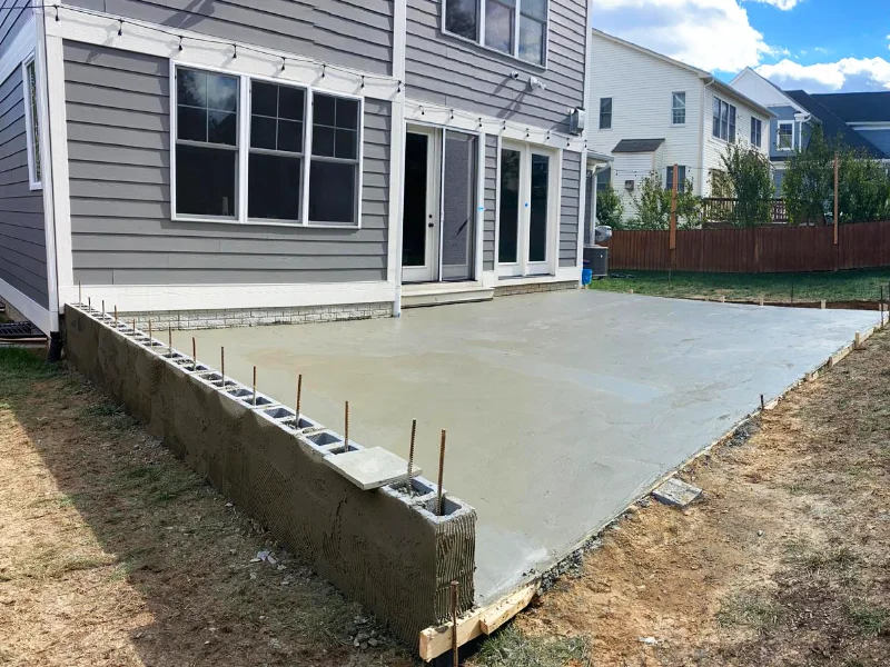 Concrete poured into forms with rebar reinforcement and block wall beginning