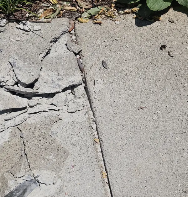 originial cracked and damage concrete driveway