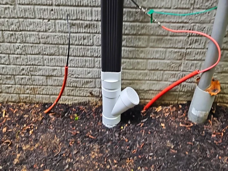 Downspout cleanout with a brand new Y-connector drainage installation
