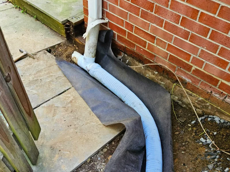 downspout connected to newly installed french drain system