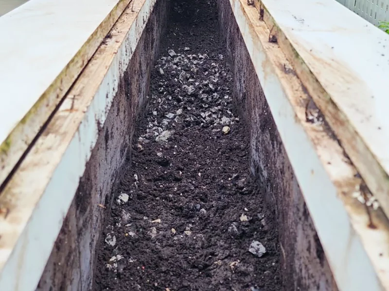 Planter area before drainage gravel installation near front entry