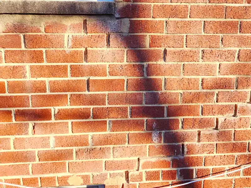 Exterior brick wall after mortar joint repair and repointing in Temple Hills, MD