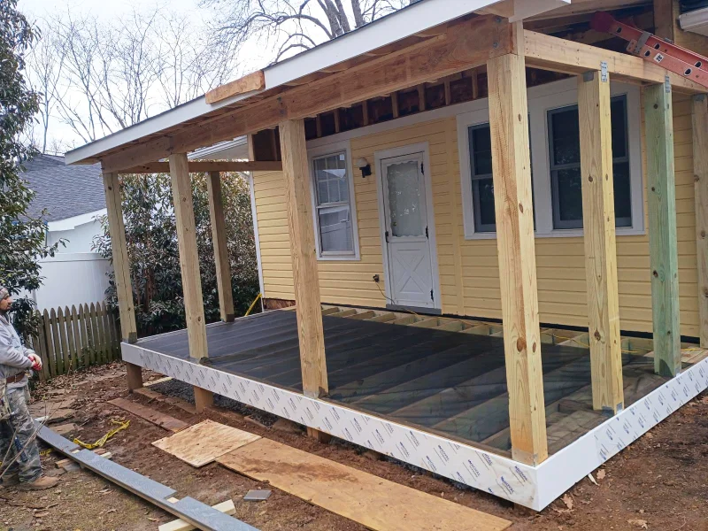 Heavy posts and beams are set to support the new roof structure, which is designed to tie seamlessly into the existing home's roofline.