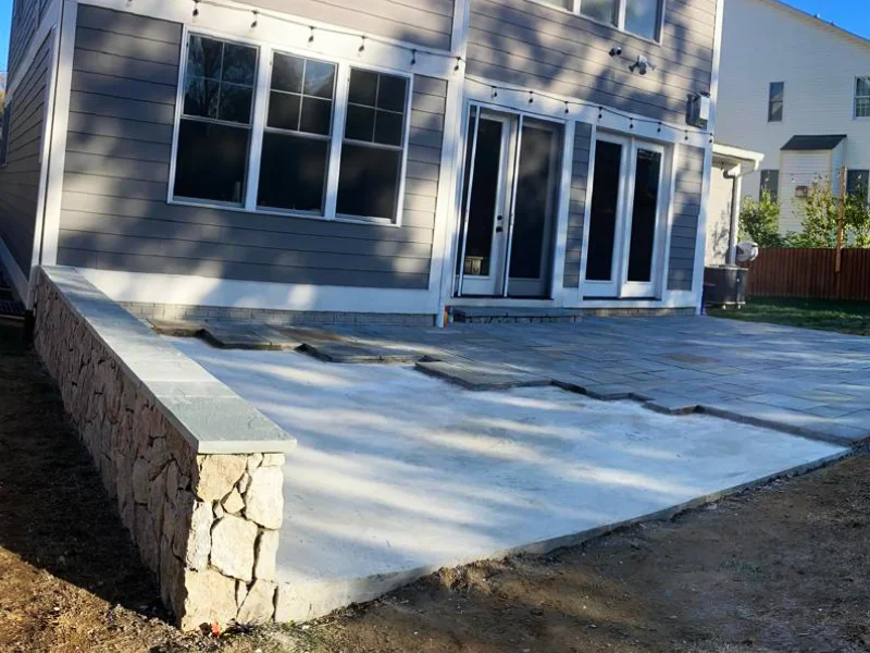 Pennsylvania Bluestone flagstone installation in progress across concrete sub-base