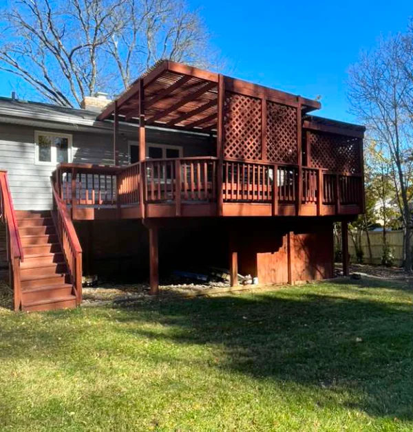 Before: Red wooden deck and pergola with no gravel swale and bench pad