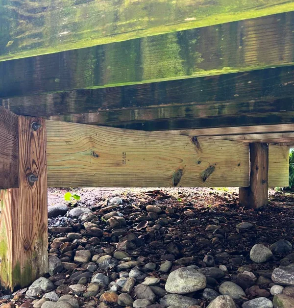 Rotted deck joists and deteriorated framing beneath elevated deck in Great Falls VA before structural repairs