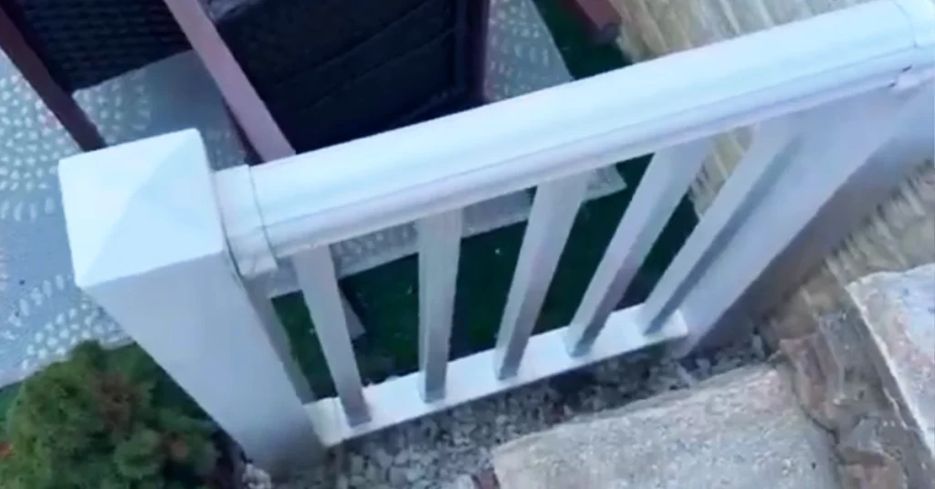 Top-down view of the old white vinyl railing positioned several inches away from the exterior stone steps.