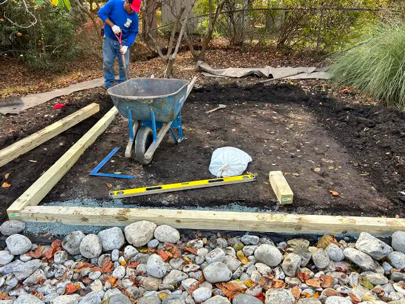 Wooden frame being installed around the bench pad by a contractor