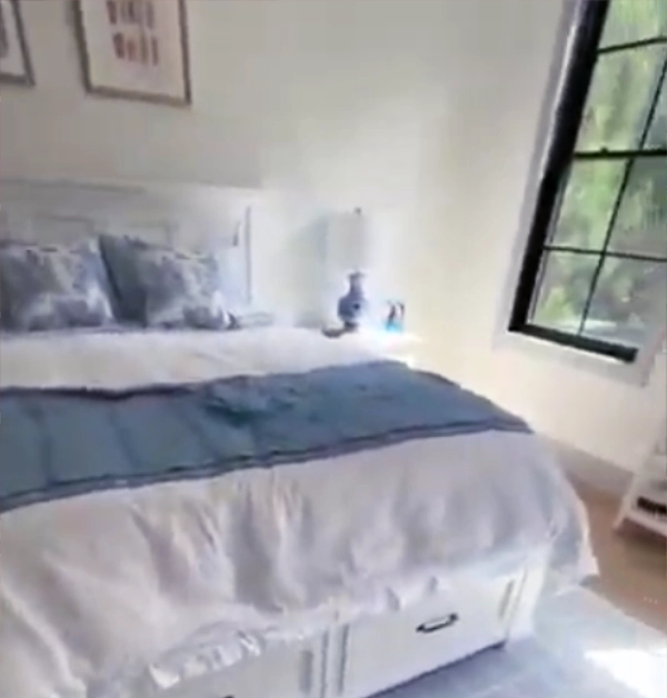 Spare bedroom before remodeling, showing a blank wall and existing room layout prior to installing custom built-in cabinetry, storage cabinets, and decorative wall molding.