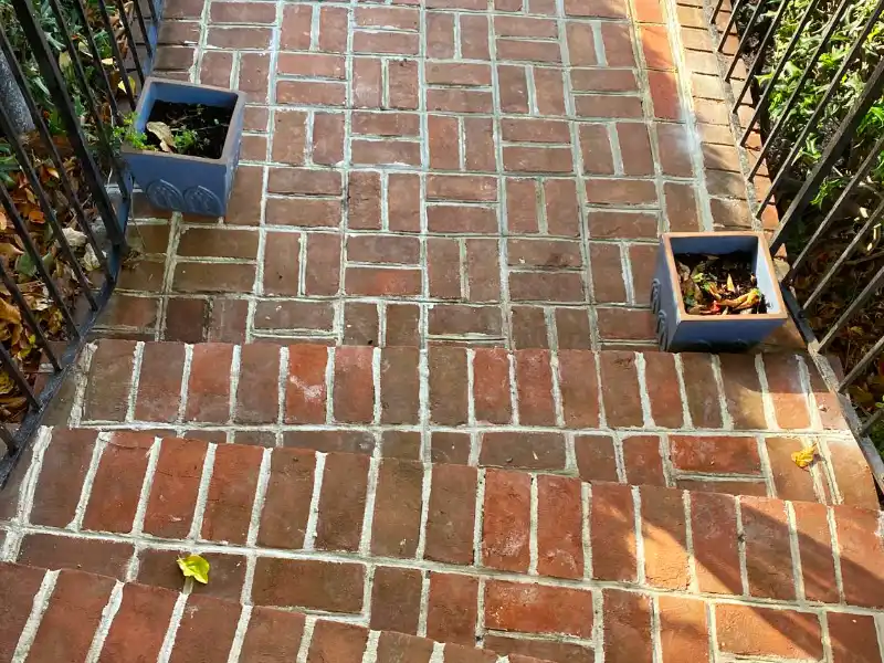 Top view of the brick landing showing deteriorated mortar joints before restoration work began.