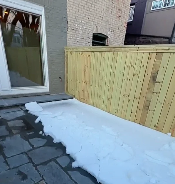 Completed flagstone patio with wooden fence for privacy in Washington, DC