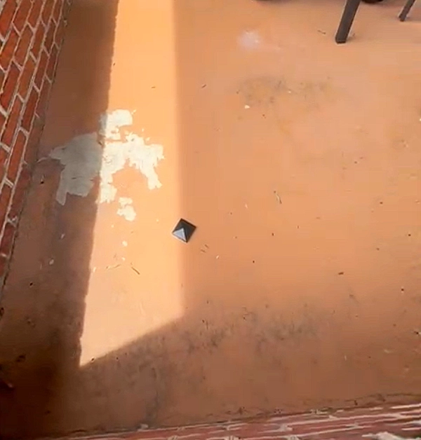 Existing covered porch floor with worn painted concrete showing discoloration and surface deterioration before resurfacing.