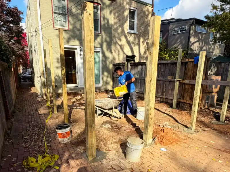 installed wooden fence with concrete slab and footing