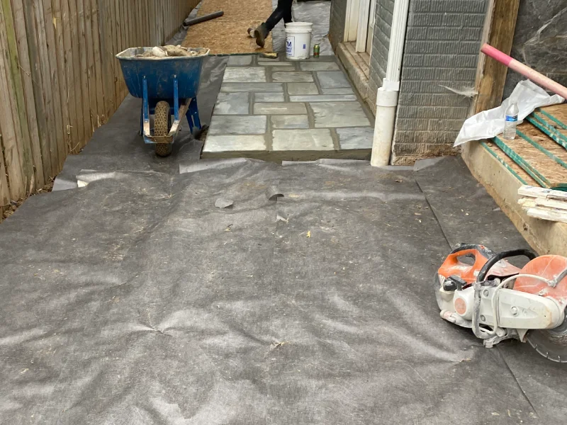 Landscape fabric installed over the newly graded side yard before placing river rock and natural flagstone.