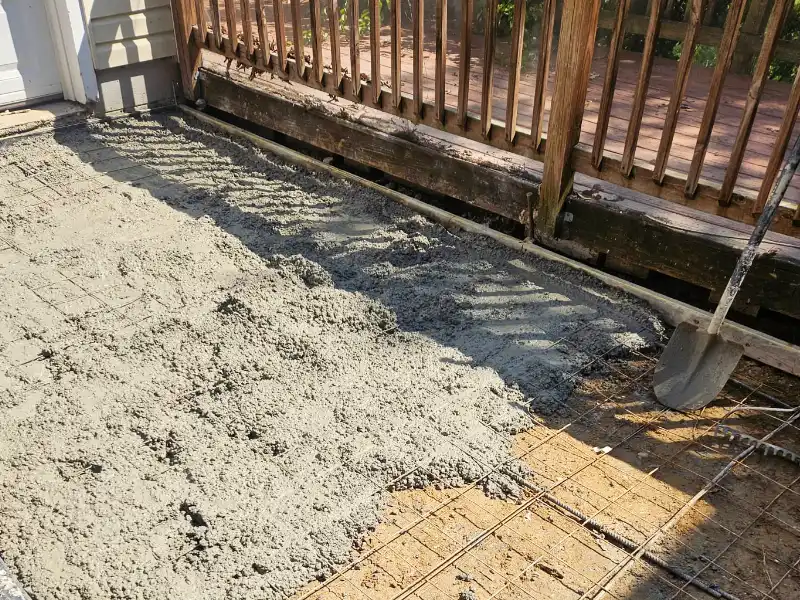 Fresh concrete being poured during rear driveway drainage correction project in College Park MD