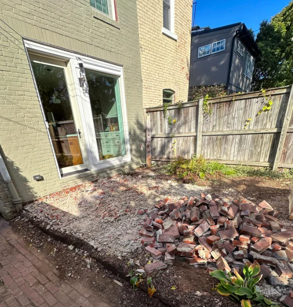 old brick patio with worn-out wooden fence in washington dc