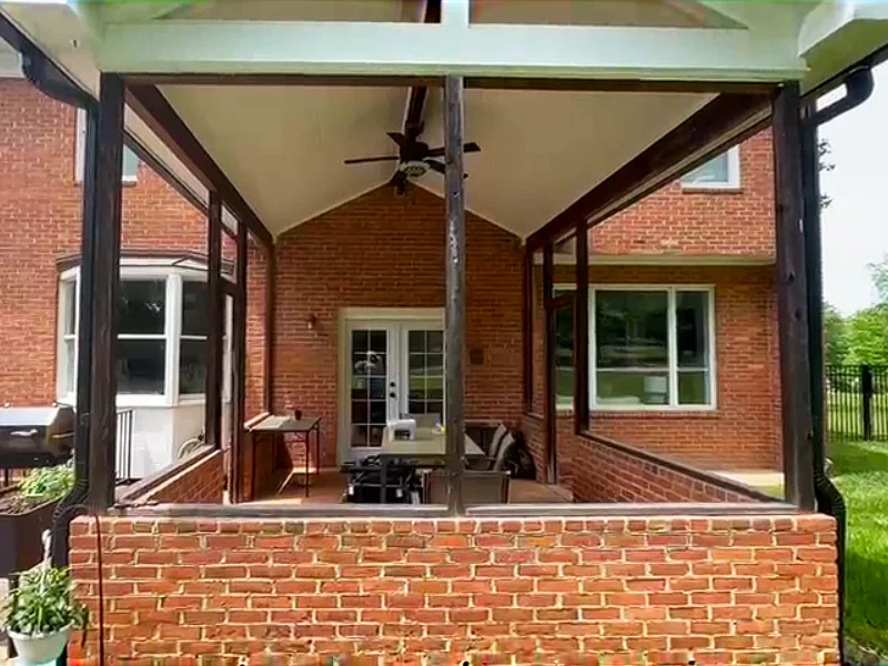 Before resurfacing, the covered porch floor had peeling paint, discoloration, and an uneven concrete surface.