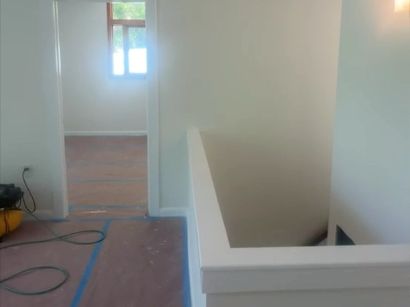Stairway and flooring protected during the basement renovation while construction work continued throughout the home.
