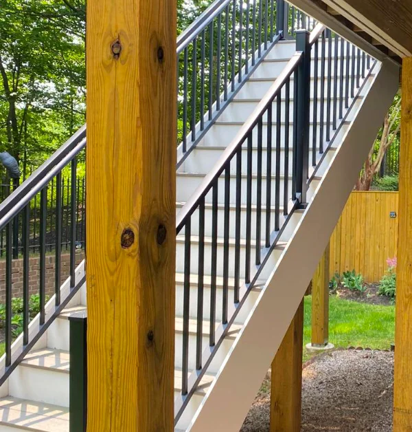 New pressure-treated support posts, reinforced and resurfaced deck framing installed beneath an elevated backyard deck after structural repairs in Potomac, MD.