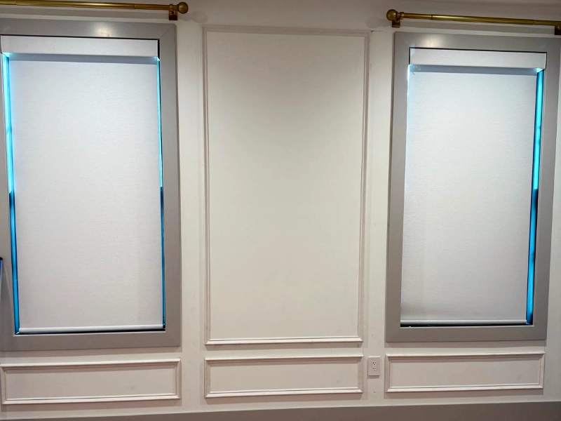 Custom wainscoting installation in progress with large upper panels and smaller lower panels being fitted along the office walls before final caulking and paint.