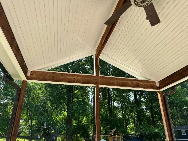 Close-up of a porch post wrapped in white PVC trim after installation, showing the clean finish and low-maintenance exterior detail.