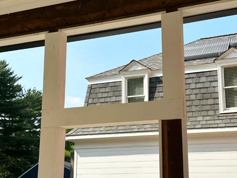 Completed porch framing wrapped in white PVC trim, creating a clean, low-maintenance finish for the screened porch.